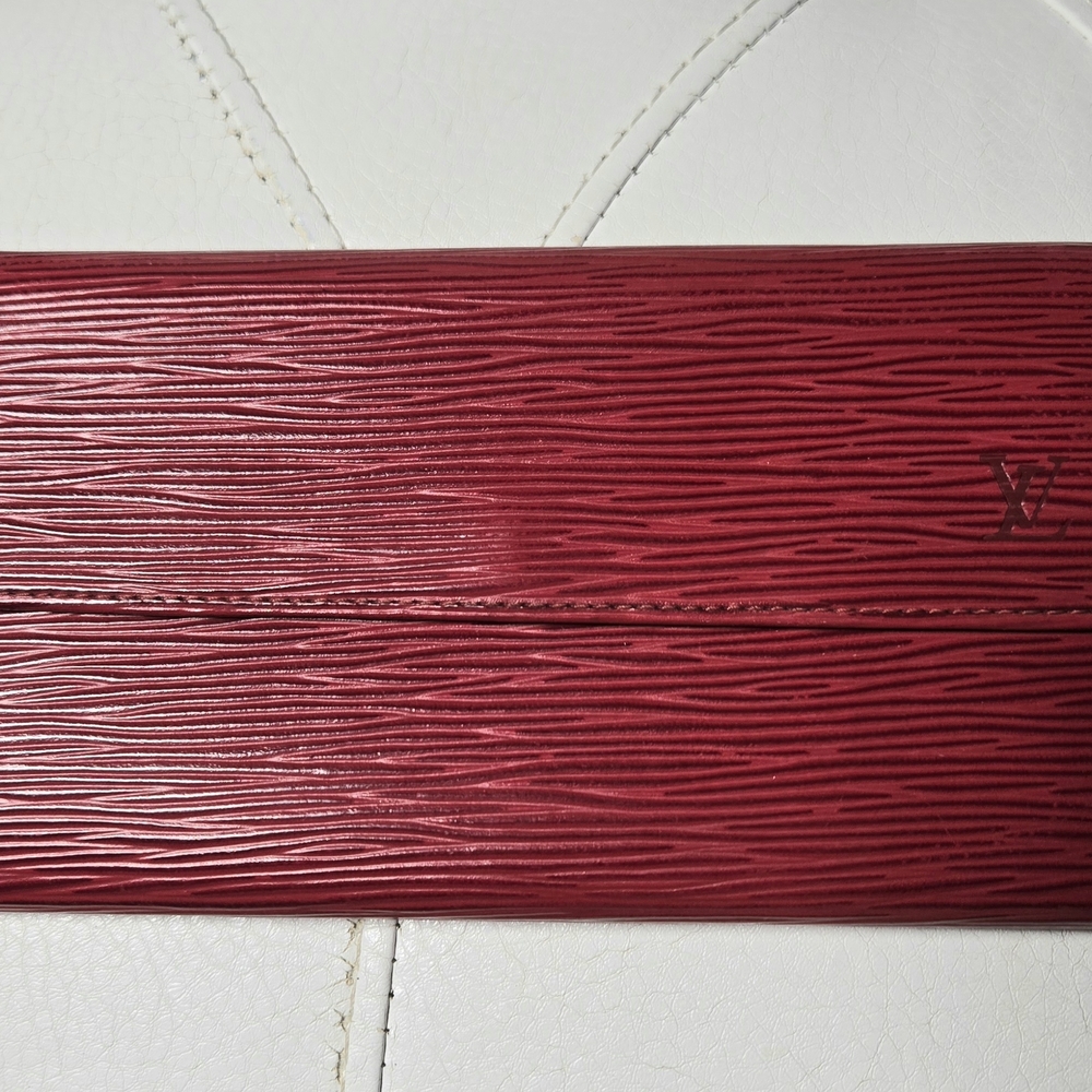 Louis Vuitton Sarah wallet in red Epi leather.